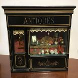 A Victorian style miniature antique shop frontage, inscribed verso, Suzanne Loftus, Brigham 1996 (