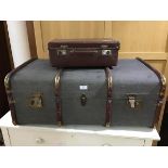 An early 20thc wooden and brass bound cabin trunk with fabric cover and leather carry handles and