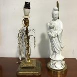 A modern blanc de chine figure of Guan Yin lamp on brass circular base and a 19thc candlestick