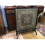 An Aesthetic ebonised firescreen, the moulded rectangular frame enclosing a tapestry panel,