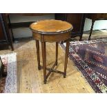 An Edwardian circular occasional table, the dished top with moulded edge above a plain frieze, on