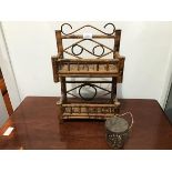 An early 20thc bamboo spice rack of two tiers with scroll crest and navette shaped decoration (