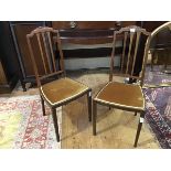 A pair of Edwardian mahogany bedroom chairs, each spar back with arched cresting rail, above