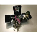 A jewellery box containing a collection of costume jewellery including necklaces, bracelets,