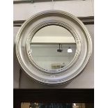 A modern circular wall mirror with moulded silvered frame and circular glass mirror plate (d.68cm)