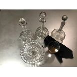 A group of three slice cut and engraved decanters, a moulded glass tazza (h.10cm x d.20cm)and a