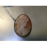 A white metal mounted oval shell carved cameo brooch (5.5cm x 4.5cm)