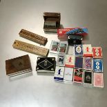 A mixed lot of games and cards including twenty two decks of cards, two cribbage boards and two sets