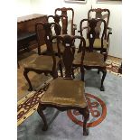 A set of four dining chairs of Queen Anne design, dating to the 1920s, with vase shaped splat and