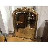 A Victorian giltwood wall mirror, the rectangular arched plate within a moulded frame with C