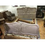 A mid 20thc French painted and carved double bed, the cartouche shaped back with central scallop