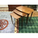 A mid century set of graduated tables, the beech and walnut frames with rectangular top, raised on