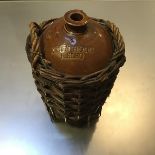 A 19thc stoneware flagon by John Hogg, Kelso, manufactured by Grays, Portobello, with wicker two