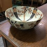 A Chinese Imari bowl with fluted decoration, radiating vertical bands of flowerheads to the well and