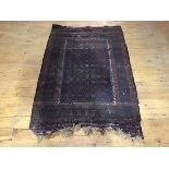 A Bokhara rug, the indigo field with rows of stylised motifs within multiple stripes in madder and