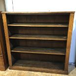 An early 20thc oak open bookcase, the rectangular top above three adjustable shelves, raised on