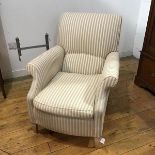 A modern easy chair in the Victorian style, the upholstered back, arms and seat in striped fabric,