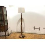 An Edwardian mahogany floor lamp, the turned baluster shaped column with reeded collar and spreading