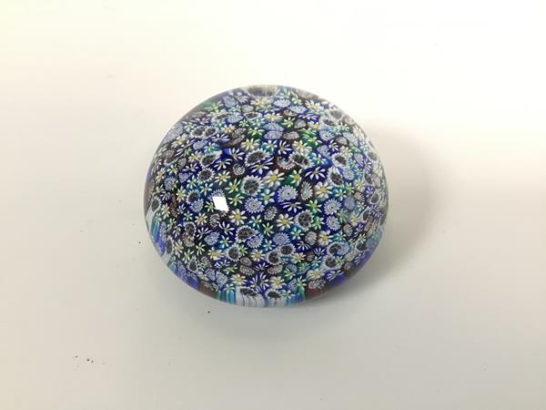 A Murano millefiore glass paperweight (d.9cm) with floral canes, paper label verso