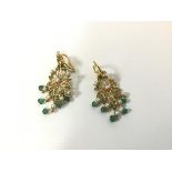 A pair of Indian yellow metal seed pearl and emerald chandelier style floral earrings with emerald