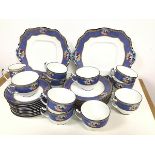 An Adderleys Suez pattern thirty one piece 1920s/30s fruit and blue and gold bordered tea set