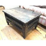 An Indian hardwood brass mounted coffee table, the rectangular top with brass mounted border and