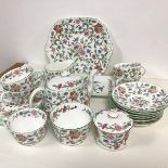 A twenty two piece Minton Haddon Hall pattern tea service including cake plates, sandwich plate,