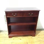 A neat modern side cabinet, the rectangular top above a pair of drawers, with shelf below, raised on