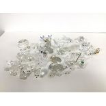 A collection of Swarofski and other crystal animals and birds including dolphins, hedgehogs,