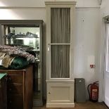 A 19thc style painted cupboard, the projecting cornice above a glazed door backed by pleated