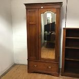 An Edwardian walnut single wardrobe, by Brown & Thomson, Aberdeen, the projecting dentil cornice