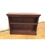 A mahogany dwarf bookcase, the stepped top above a single adjustable shelf, raised on a plinth