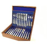 An Edwardian oak canteen containing a set of twelve pairs of Epns fruit knives and forks
