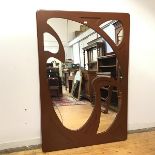 A painted wall mirror of Art Nouveau design, the rectangular mirror plate applied with fretwork