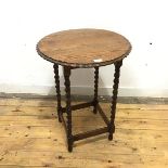 A 1920s oak occasional table, the circular top with faceted border on spiral turned supports