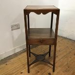 A George III mahogany and later washstand, the associated square top covering the dished basin