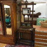 An Edwardian oak hallstand, the raised back with pierced crest and incorporating a rectangular