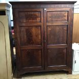 A Scottish late Regency mahogany wardrobe, the projecting cornice with bead detail above a pair of