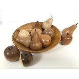 A treen carved bowl (h.6cm x d.27cm) with a collection of treen pears and apples, carved from