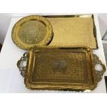 A brass galleried drinks tray with Chinese engraved decoration depicting figures in a garden (46cm x