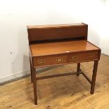 A mid century teak campaign style writing desk, the raised superstructure with fall front
