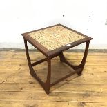 A G Plan occasional table, the square top inset with four ceramic tiles raised on hooped supports
