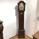 A small 20thc longcase clock, the moulded arched hood enclosing a triple chain movement, chiming