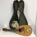 A vintage eight string mandolin complete with hard case (62cm x 20cm)