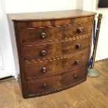 A mahogany chest of drawers, c.1830, the rectangular bow fronted top above two short and three