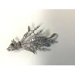 A 1920s/30s white metal diamond spray and ribbon floral brooch (5.5cm x 3cm), with brilliant cut