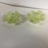 A pair of vaseline glass candleholders with a ruffled edge on a circular foot (h.3cm)