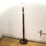 A modern wooden floor lamp, the turned shaft raised on a circular dished base (h.135cm)