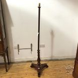 A mahogany standard lamp, converted from a Victorian polescreen, the later turned shaft with