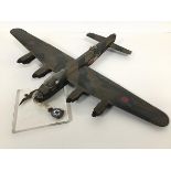 A model of a Lancaster bomber, complete with stand with RAF badge and Squadron Royal Airforce badge